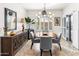 Elegant dining area features modern lighting, stylish chairs, and tasteful decor, perfect for entertaining at 1475 N Agave St, Casa Grande, AZ 85122
