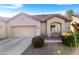 Charming single-story home with a two car garage, desert landscaping, and a cozy bench at 1475 N Agave St, Casa Grande, AZ 85122