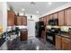 Well-lit kitchen featuring granite counters, and wooden cabinetry with black appliances at 1475 N Agave St, Casa Grande, AZ 85122