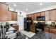 Modern kitchen featuring dark appliances, stone countertops, and plenty of cabinet space for storage at 1475 N Agave St, Casa Grande, AZ 85122