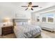 Serene bedroom with tile floors, neutral tones, a ceiling fan, and bright windows, creating a calm retreat at 1475 N Agave St, Casa Grande, AZ 85122