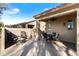 Covered patio with outdoor seating and ceiling fan perfect for entertaining at 1475 N Agave St, Casa Grande, AZ 85122