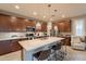 Modern kitchen with quartz countertops, stainless steel appliances, and a center island at 1476 W Sonoqui Blvd, San Tan Valley, AZ 85140