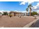 Cozy single-story home with a well-maintained exterior, decorative yard ornaments, and low maintenance desert landscaping at 1779 S 74Th St, Mesa, AZ 85209