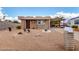 Charming single-story home featuring a quaint front yard, mature cactus, and covered parking at 1779 S 74Th St, Mesa, AZ 85209