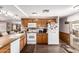 Traditional kitchen with wooden cabinets, white appliances, and dark wood floors at 1779 S 74Th St, Mesa, AZ 85209