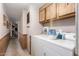 Convenient laundry room featuring a washer, dryer, and overhead cabinets at 1779 S 74Th St, Mesa, AZ 85209