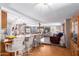 Open concept living room, seamlessly flowing into the kitchen, with barstool seating, a ceiling fan, and warm finishes at 1779 S 74Th St, Mesa, AZ 85209