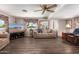Well-lit living room with wood-look floors, cozy seating, and a view into the adjacent kitchen at 1779 S 74Th St, Mesa, AZ 85209
