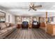 Inviting living room with wood-look floors, a ceiling fan, and ample seating for Gathering and friends at 1779 S 74Th St, Mesa, AZ 85209
