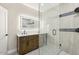Updated bathroom with dual sinks, stylish vanity and a modern glass enclosed shower at 2202 E Osborn Rd, Phoenix, AZ 85016