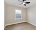 Small bedroom featuring new wood-look flooring, neutral walls, a ceiling fan, and a single window at 2202 E Osborn Rd, Phoenix, AZ 85016