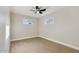 A bedroom featuring a ceiling fan, new wood-look flooring, neutral walls, and two windows at 2202 E Osborn Rd, Phoenix, AZ 85016