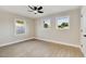 Bedroom featuring new wood-look flooring, neutral walls, a ceiling fan, and two windows offering natural light at 2202 E Osborn Rd, Phoenix, AZ 85016