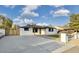 Attractive home showcasing a long driveway, minimalist landscaping, and inviting covered entry at 2202 E Osborn Rd, Phoenix, AZ 85016