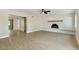 Bright living room featuring a painted brick fireplace, a ceiling fan, and light wood-look floors at 2202 E Osborn Rd, Phoenix, AZ 85016