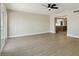 Open floor plan featuring a ceiling fan, neutral walls, and light wood-look flooring that lead into the kitchen at 2202 E Osborn Rd, Phoenix, AZ 85016
