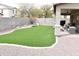 A backyard featuring artificial grass, a playground, a patio, and a block wall at 25776 N Sandstone Way, Surprise, AZ 85387
