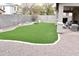 Backyard featuring green turf, playset and outdoor seating beneath covered patio at 25776 N Sandstone Way, Surprise, AZ 85387