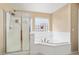 Bathroom featuring a shower and bathtub, with a frosted window for natural light at 25776 N Sandstone Way, Surprise, AZ 85387