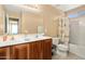 Bathroom featuring double sinks, wood cabinets, and a bathtub with a shower curtain at 25776 N Sandstone Way, Surprise, AZ 85387