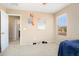 Bedroom with a window view, carpeted floor and an open door to the bathroom at 25776 N Sandstone Way, Surprise, AZ 85387