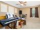 A bedroom featuring a ceiling fan, beige walls, carpet flooring, and a window at 25776 N Sandstone Way, Surprise, AZ 85387