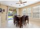 Bright dining area with tile flooring, natural light, and a sliding glass door to backyard at 25776 N Sandstone Way, Surprise, AZ 85387
