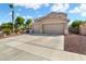 Charming two-story home with a three-car garage, desert landscaping, and driveway at 25776 N Sandstone Way, Surprise, AZ 85387