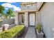 Covered front entryway with decorative door and stone pillars at 25776 N Sandstone Way, Surprise, AZ 85387