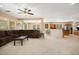 Comfortable living room featuring a ceiling fan and open floor plan leading into the kitchen at 25776 N Sandstone Way, Surprise, AZ 85387