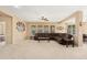 Spacious living room with neutral carpet and cozy brown sectional at 25776 N Sandstone Way, Surprise, AZ 85387