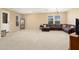 Large living room with neutral carpet and a spacious seating area at 25776 N Sandstone Way, Surprise, AZ 85387
