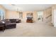 Spacious living room with neutral carpet, paint, and a cozy brown sectional at 25776 N Sandstone Way, Surprise, AZ 85387