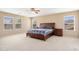 Large main bedroom with natural lighting from many windows and a ceiling fan at 25776 N Sandstone Way, Surprise, AZ 85387