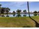 Scenic view of a tranquil pond surrounded by lush greenery and mature trees at 26235 S Lakeview Dr, Sun Lakes, AZ 85248