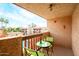 Cozy balcony with views of the pool, outdoor table with chairs, and a bottle of wine for outdoor relaxation at 3031 N Civic Center Plz # 306, Scottsdale, AZ 85251