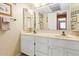 Bathroom featuring double sinks with white cabinets and a large mirror at 3031 N Civic Center Plz # 306, Scottsdale, AZ 85251