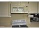 Modern white microwave and range with a partial view of the dining area at 3031 N Civic Center Plz # 306, Scottsdale, AZ 85251