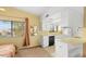 Cozy kitchenette includes a white cabinets, black appliances, and bar seating at 3031 N Civic Center Plz # 306, Scottsdale, AZ 85251