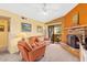 Inviting living area with a brick fireplace, comfortable seating, and a sliding door to the outdoor patio at 3031 N Civic Center Plz # 306, Scottsdale, AZ 85251
