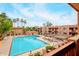 Community pool view with palm trees and blue sky, providing a relaxing resort-like experience at 3031 N Civic Center Plz # 306, Scottsdale, AZ 85251