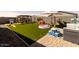 Backyard with artificial grass, a play area, outdoor seating, and a patio at 37236 N Navarra Rd, San Tan Valley, AZ 85140