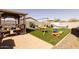 Backyard featuring a play area, shed and artificial turf at 37236 N Navarra Rd, San Tan Valley, AZ 85140