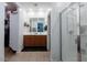 Bathroom with wood cabinet, double sinks, shower, and tiled floor at 37236 N Navarra Rd, San Tan Valley, AZ 85140