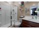 Well-lit bathroom with a glass-enclosed shower, dark wood vanity, and essential fixtures at 37236 N Navarra Rd, San Tan Valley, AZ 85140