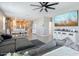 Inviting open-concept living room with a large sectional sofa and adjacent kitchen and dining area at 37236 N Navarra Rd, San Tan Valley, AZ 85140