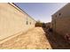 A home side yard with dirt, fences, and landscaping potential at 37236 N Navarra Rd, San Tan Valley, AZ 85140