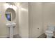 Bathroom featuring a pedestal sink, neutral color palette, and modern fixtures at 3802 E Stiles Ln, Gilbert, AZ 85295