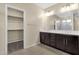 Spacious bathroom features dual sinks, custom cabinets, an enclosed glass shower, and walk-in closet at 3802 E Stiles Ln, Gilbert, AZ 85295